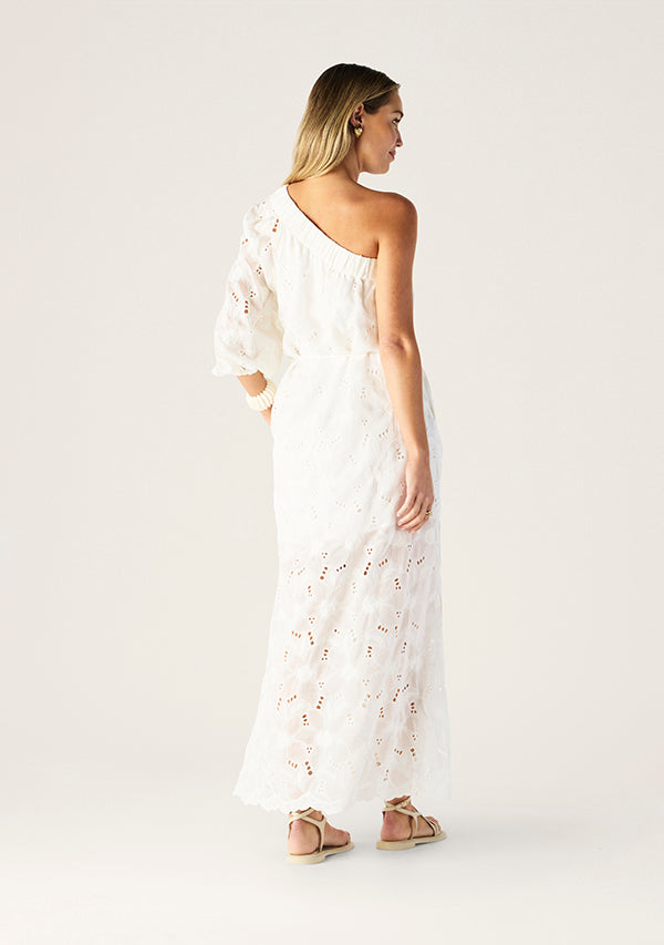 Woman wearing a white lace dress on a plain background